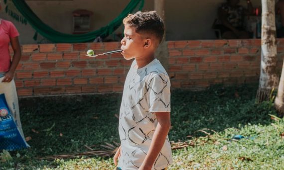 boy in white and black button up shirt playing bubbles